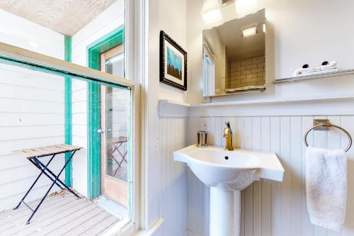 a bathroom with a sink and a window at Old Town Cottage in Steamboat Springs