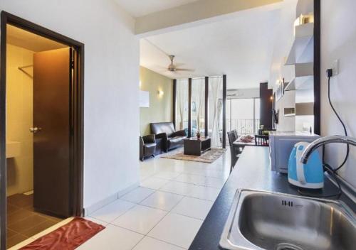 a kitchen with a sink and a living room at 5min Mid Valley Southkey 10min KSL CIQ City Square in Johor Bahru