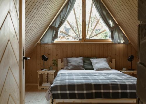 a bed in a room with a window at Domek Pod Lipkami in Zakopane