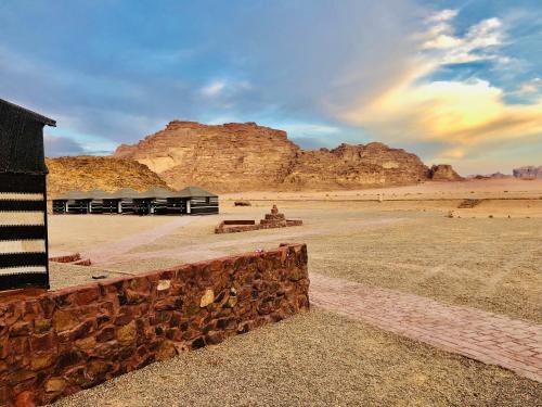 a building in the desert with a mountain in the background at Shakria Bedouin Life Camp in Wadi Rum