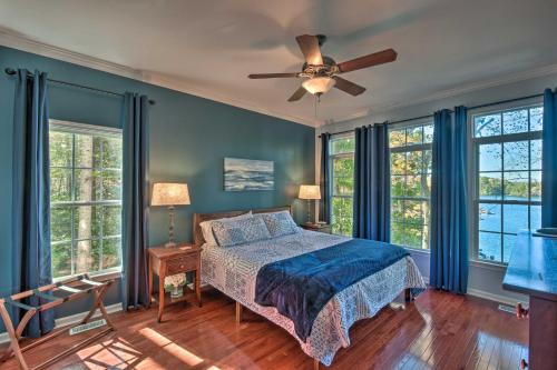 a bedroom with a bed and a ceiling fan at Lake Keowee Escape with Dock, Deck and Lake Access! in Six Mile