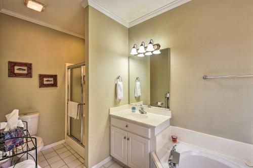 a bathroom with a sink and a mirror and a tub at Lake Keowee Escape with Dock, Deck and Lake Access! in Six Mile