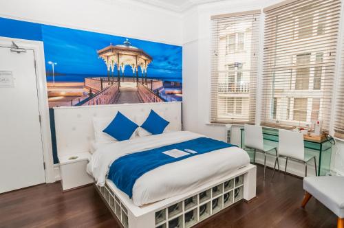 a bedroom with a bed with a painting on the wall at Hotel Nineteen in Brighton & Hove