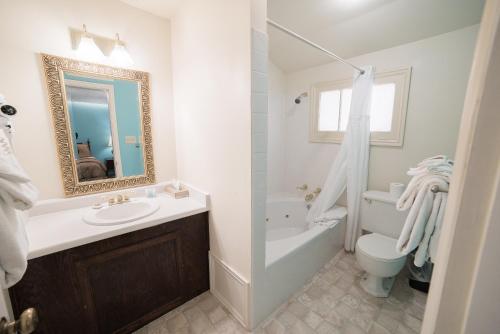 a white bathroom with a sink and a toilet at Parry Lodge in Kanab