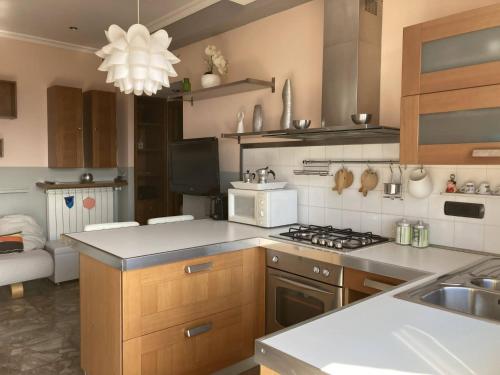 a kitchen with a sink and a stove top oven at Ciampino Airport Apartment in Ciampino