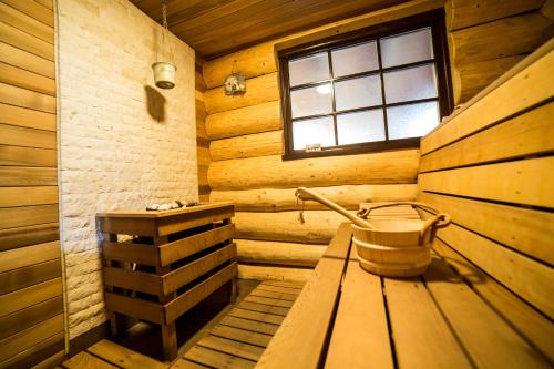 a wooden room with a tub and a window at Casa de Munte in Vatra Dornei