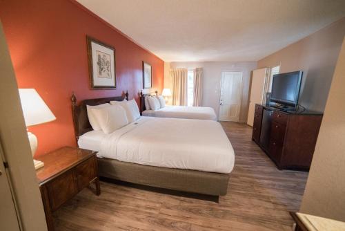 a hotel room with two beds and a flat screen tv at Parry Lodge in Kanab