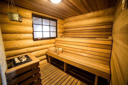 a wooden sauna with a bench and a window at Casa de Munte in Vatra Dornei