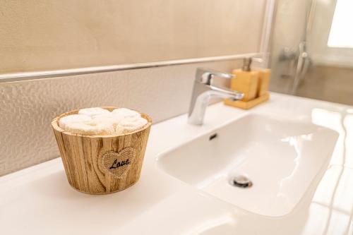 a bathroom sink with a container of toilet paper on it at Top floor with ocean view in Adeje