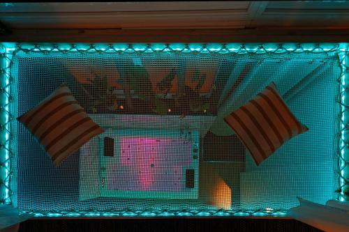 a fireplace with two striped pillows in it at Romance spa tropical Le Havre in Le Havre