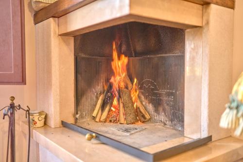 a fireplace with a fire in it at Agriturismo Selvella in Radicofani