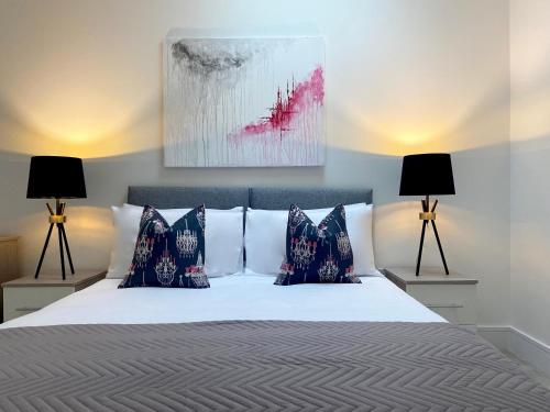 a bedroom with a bed with two lamps at Peak at Fleet Heights Apartment Four in Fleet