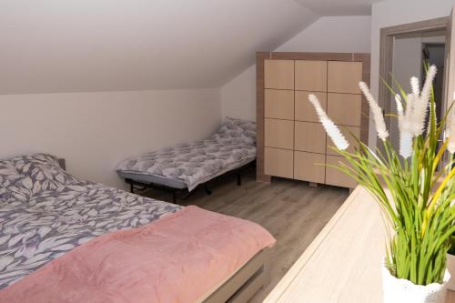 a bedroom with a bed and a dresser at Domek całoroczny w Karkonoszach in Jelenia Góra