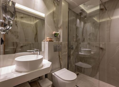 a bathroom with a toilet sink and a shower at Chrousso Village in Paliouri