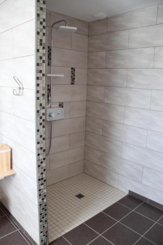 a shower with a glass door in a bathroom at le haut village chambres d'hôtes en baie de somme in Arrest