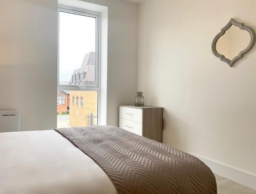 a bedroom with a bed with a mirror and a window at Skyline at Fleet Heights Apartment Six in Fleet