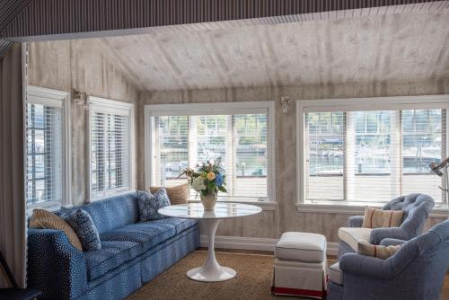 a living room with two blue couches and a table at The White Barn Inn & Spa, Auberge Collection in Kennebunk