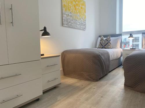 a bedroom with a bed and a dresser and a drawer at Apex at Fleet Heights Apartment Five in Fleet
