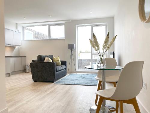 a living room with a table and a couch at Horizon at Fleet Heights Apartment Eight in Fleet
