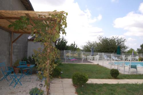 a garden with a pool with a table and chairs at Chateau de Faudade in Lévignac-sur-Save