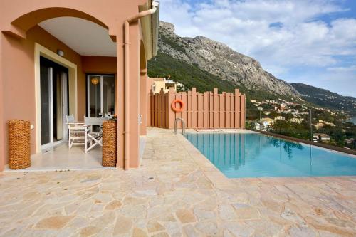 a villa with a swimming pool and a mountain at Villa Renata Gold in Barbati