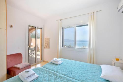 a bedroom with a bed and a large window at Villa Renata Gold in Barbati