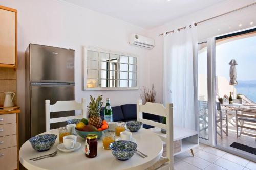 a kitchen with a table and a refrigerator at Villa Renata Gold in Barbati