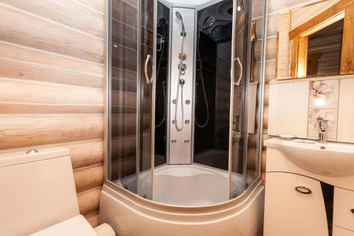 a shower in a bathroom with a toilet and a sink at М House in Vorokhta