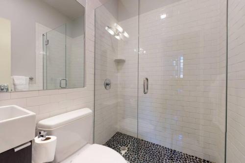 a bathroom with a toilet and a glass shower at South End Studio, Ideal for Boston Travelers #23 in Boston