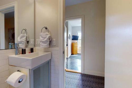a bathroom with a white sink and a mirror at Stylish Downtown Studio in the Boston, C.Ave #34 in Boston
