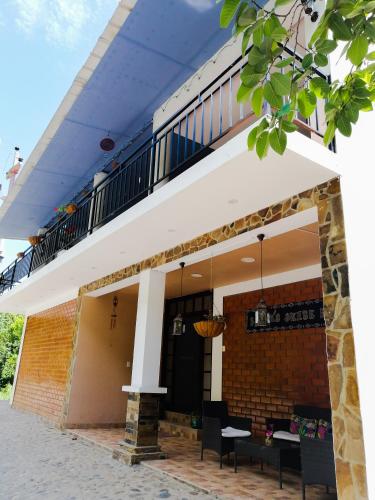 a building with a balcony with tables and chairs at Zoila's Suite Escape in Nuevo Tingo
