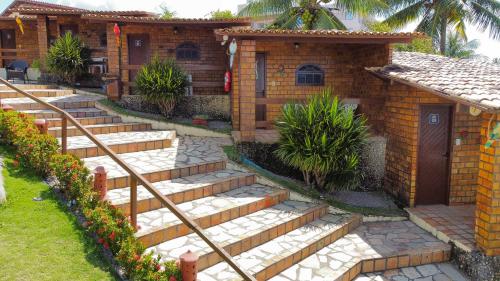 a set of stairs leading to a house at Pousada Enseada do Sol in Jacumã