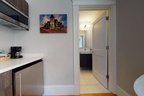 a kitchen with a white counter top and a sink at A Stylish Stay w/ a Queen Bed, Heated Floors.. #22 in Brookline