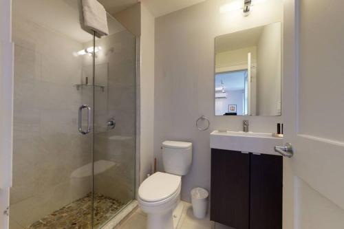 a bathroom with a toilet and a shower and a sink at A Stylish Stay w/ a Queen Bed, Heated Floors.. #12 in Brookline