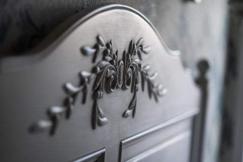 a close up of a white wooden chair with a design on it at Boutique Hotel Anagennisis in Pýrgos