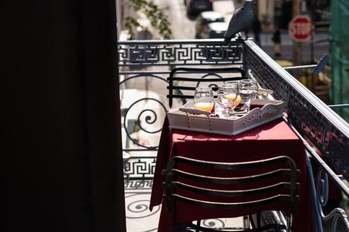 a table with a tray of food and glasses on it at Boutique Hotel Anagennisis in Pýrgos