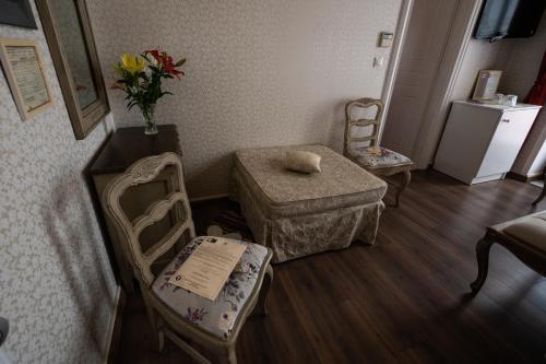 a living room with a chair and a table and a couch at Boutique Hotel Anagennisis in Pýrgos
