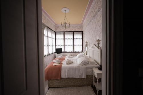 a bedroom with a bed and a window at Boutique Hotel Anagennisis in Pýrgos