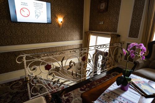 a stair case with a glass railing and flowers on it at Boutique Hotel Anagennisis in Pýrgos