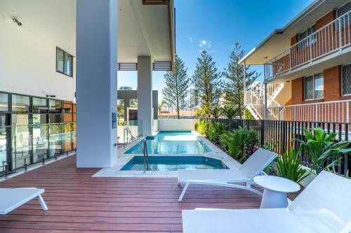 a balcony with a swimming pool in a building at Opus Broadbeach - Official in Gold Coast