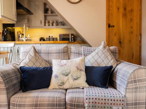 a couch with pillows on it in a kitchen at Hush Cottage in Middleton in Teesdale