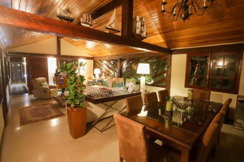 a living room with a dining table and a living room at Búzios House Oficial in Búzios