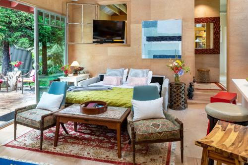 a living room with a bed and a table and chairs at Volcano Village Estates in Volcano