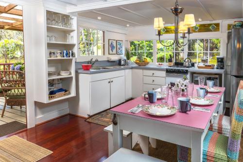 a kitchen with a pink table in a room at Volcano Village Estates in Volcano
