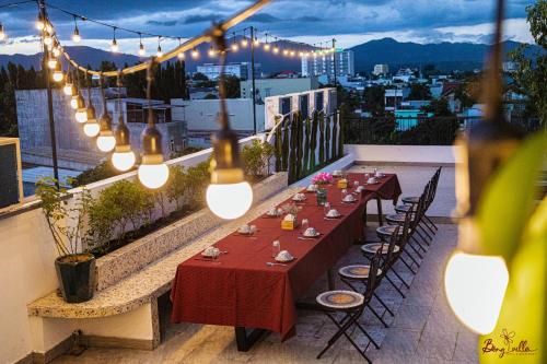 a table on the roof of a building with lights at Bông Villa Hotel & Apartment in Kon Tum