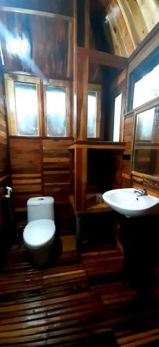 a bathroom with a toilet and a sink at Green Bamboo Lodge Resort in Cat Tien