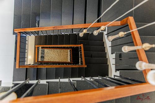 a mirror on the side of a room with stairs at Bông Villa Hotel & Apartment in Kon Tum