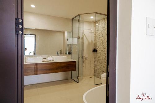 a bathroom with a shower and a sink and a toilet at Bông Villa Hotel & Apartment in Kon Tum