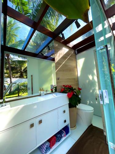 a bathroom with a white sink and a mirror at Búzios House Oficial in Búzios