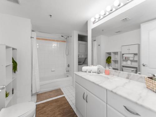 a white bathroom with a toilet and a sink at Fabulous apartment in Brickell in Miami